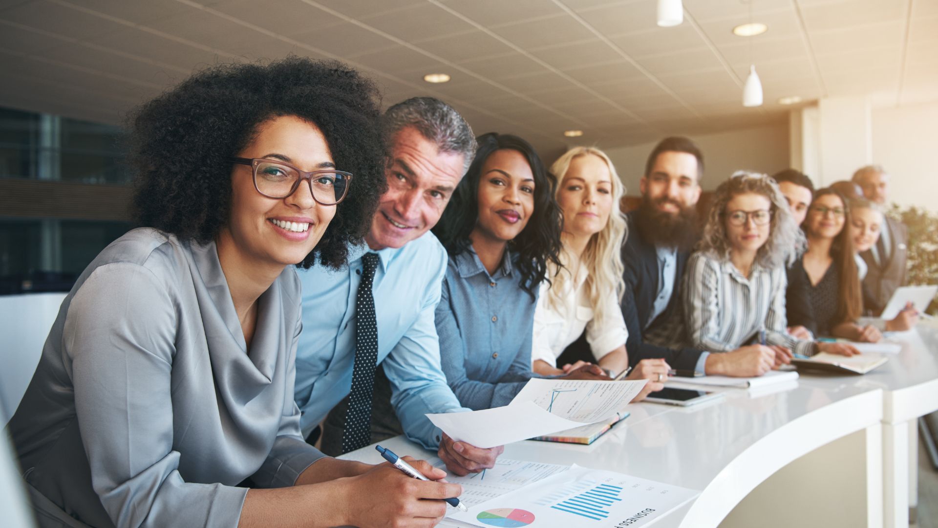 A group of diverse business people sitting at a boardroom table