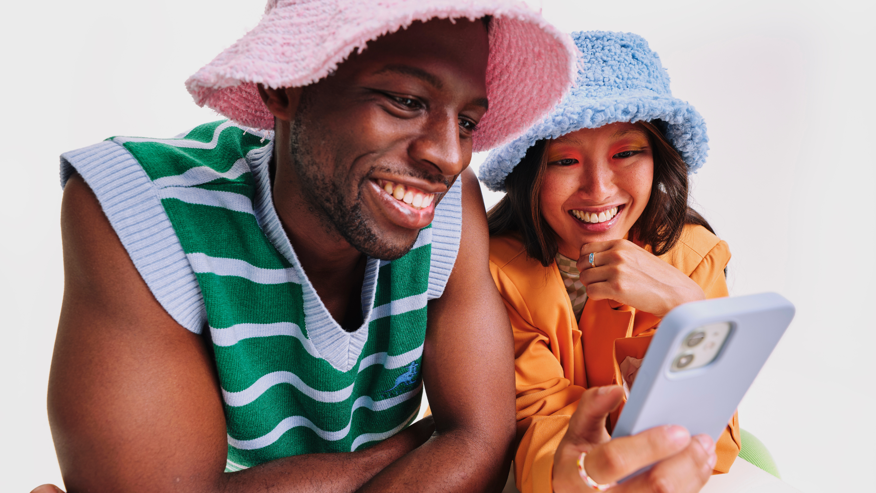 Trendy millennials looking at a cellphone serving as brand loyalty examples